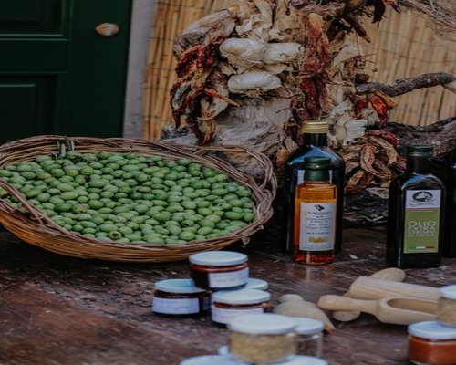 A bottle of fresh olive oil on a wooden table